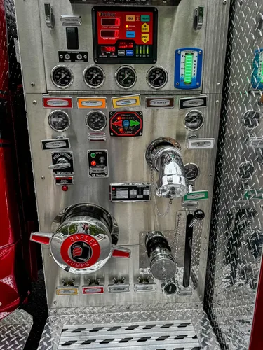 Pump panel detail showing intake/discharge hardware and control labels.